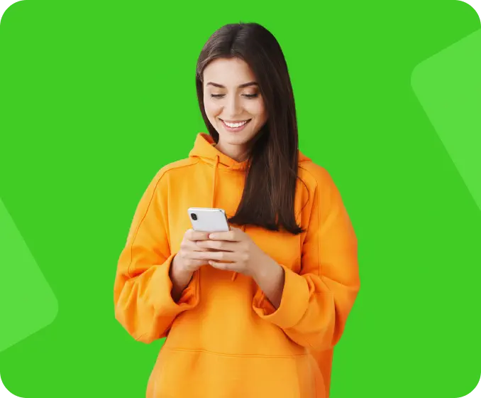 A young woman in a yellow sweater looking at her smart phone